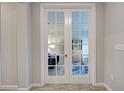 A stylish set of French doors leads into the office area with beautiful decor at 11842 Sistine Ln, Venice, FL 34293