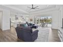 Open living space with hardwood floors, sectional sofa, and views of the pool at 12353 Auburndale Ct, Venice, FL 34293