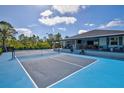 Entertain in this expansive backyard, with an outdoor lounge space and a sleek private pickleball court at 14098 Baracoa Ln, Port Charlotte, FL 33981