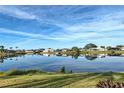Tranquil lakefront property with reflections of homes under a vibrant sky at 1723 N Gondola Ct, Venice, FL 34293
