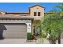 Two-story home with attached garage and landscaped entry at 23471 Awabuki Dr, Venice, FL 34293