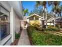 A walkway leads to the front entrance, surrounded by well-maintained landscaping and palm trees at 237 Southampton Ln # 275, Venice, FL 34293