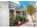 A charming, private patio area with lush tropical plants and decorative pots at 237 Southampton Ln # 275, Venice, FL 34293