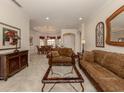 Open living and dining area with tile floors and rich brown furniture at 298 Montelluna Dr, North Venice, FL 34275