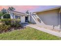 Charming front entrance with well maintained yard, stone landscaping, and a smooth walkway at 301 Pinebrook Club Dr # 1, Venice, FL 34285