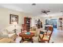 Spacious living room featuring tile floors, a ceiling fan, and traditional furnishings creating a comfortable atmosphere at 3151 Datura Rd, Venice, FL 34293