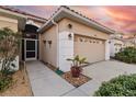 Front entrance and walkway leading to garage at 320 Langholm Dr, Venice, FL 34293