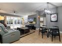 Spacious living area with large TV, comfortable seating, and dining space at 320 Langholm Dr, Venice, FL 34293