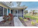 Inviting screened porch with seating area, perfect for relaxing at 324 Monet Dr, Nokomis, FL 34275