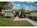 Single story home with a welcoming entryway and tropical landscaping at 339 Meadow Beauty Ct, Venice, FL 34293