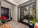 Inviting front porch with potted plants and a screen door at 341 Pembroke Ln # 227, Venice, FL 34293