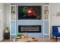Comfortable living room features a modern electric fireplace and a large flatscreen TV at 3560 Middletown St, Port Charlotte, FL 33952