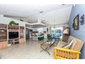 Open living room and kitchen with a view of the pool at 4695 W Price Blvd, North Port, FL 34286