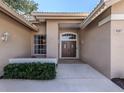 Front entrance with double doors and landscaping at 487 Summerfield Way, Venice, FL 34292