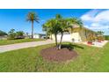 House exterior showcasing landscaping and a large palm tree at 49 Perimeter Dr, Englewood, FL 34223