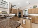 Spacious kitchen with granite counters and island at 5031 Bella Terra Dr, Venice, FL 34293