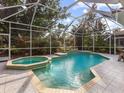 Relaxing screened pool and spa with tiled deck at 5031 Bella Terra Dr, Venice, FL 34293