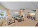 Bright living room with comfy seating, large TV, and access to other rooms at 521 Roma Road, Venice, FL 34285