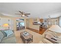 Open-concept living room with hardwood floors, kitchen pass-through, and seating area at 521 Roma Road, Venice, FL 34285