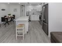 Bright, renovated kitchen featuring an island with a stool, stainless appliances, and eat-in dining space at 525 Manatee Ct # 4, Venice, FL 34285