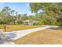 Property's aerial view showing house, driveway, and surrounding landscape at 610 Woodview Way, Bradenton, FL 34212