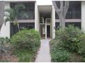 Condominium exterior showcasing well-maintained landscaping and access to upper-level units at 622 Bird Bay S Dr # 101, Venice, FL 34285