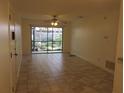 Neutral living area featuring tile flooring, a ceiling fan, and sliding glass doors to the lanai at 622 Bird Bay S Dr # 101, Venice, FL 34285