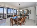 Bright dining room with glass-top table and balcony access at 627 Alhambra Rd # 601, Venice, FL 34285