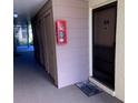 Condo hallway with doors and fire extinguisher at 634 Bird Bay E Dr # 103, Venice, FL 34285