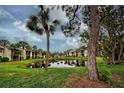 Serene pond view in a condo community with tropical landscaping at 647 White Pine Tree Rd # 34, Venice, FL 34285