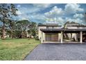 Condo building with carport and access to green space at 647 White Pine Tree Rd # 34, Venice, FL 34285