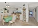 Condo dining room with kitchen pass-through and view to living room at 756 White Pine Tree Rd # 211, Venice, FL 34285