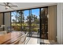 Bright dining area with sliding doors leading to a private deck at 784 Bird Bay Way # 105, Venice, FL 34285