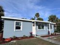 Newly renovated light blue house with landscaped yard at 8500 Agress Ave, North Port, FL 34287