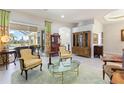 Living room with French doors opening to a pool and patio area at 1010 Grouse Way, Venice, FL 34285