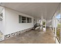 Covered carport with concrete slab at 115 White Oak Way, Sarasota, FL 34237