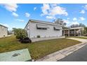 Landscaped mobile home with carport at 115 White Oak Way, Sarasota, FL 34237