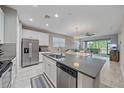 Modern kitchen featuring stainless steel appliances and a large island at 12029 Tapestry Ln, Venice, FL 34293