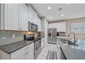 Bright kitchen with white cabinets, gray countertops, and subway tile backsplash at 12029 Tapestry Ln, Venice, FL 34293