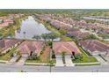 Community overview featuring lakefront villas and lush landscaping at 1375 Maseno Dr, Venice, FL 34292