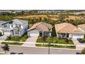 Three homes showcasing a community with similar architecture and landscaping at 17953 Grand Prosperity Dr, Venice, FL 34293