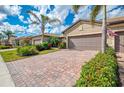Charming single-story homes featuring two-car garages, well-manicured landscaping, and paver driveways at 18861 Bianchi St, Venice, FL 34293