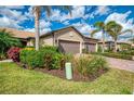 Charming single-story home featuring a two-car garage, well-manicured landscaping, and a paver driveway at 18861 Bianchi St, Venice, FL 34293