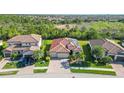 Aerial view of a neighborhood showcasing the home's location and proximity to surrounding green spaces at 20590 Granlago Dr, Venice, FL 34293