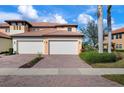 Two-car garage and brick paver driveway at 23499 Awabuki Dr # 102, Venice, FL 34293