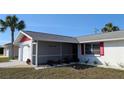 Single-story house with a red roof, white exterior, and a screened porch at 237 Venice East Blvd, Venice, FL 34293