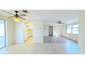 Spacious living room with tile and wood flooring, and a view into the kitchen at 237 Venice East Blvd, Venice, FL 34293