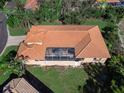 Top-down view of a home with a screened-in patio and tile roof at 249 Rio Terra, Venice, FL 34285