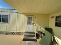 Mobile home entryway with steps and patio furniture at 269 Outer Dr, Venice, FL 34285