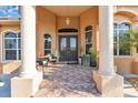 Covered front porch with seating area and decorative plants at 3162 Cordova Ter, North Port, FL 34291